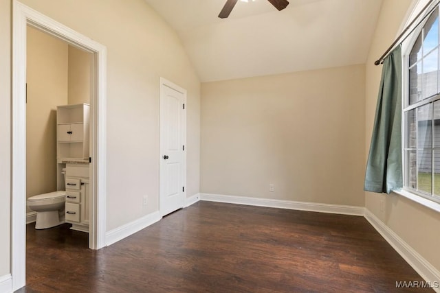 unfurnished bedroom with multiple windows, lofted ceiling, dark hardwood / wood-style floors, and ceiling fan