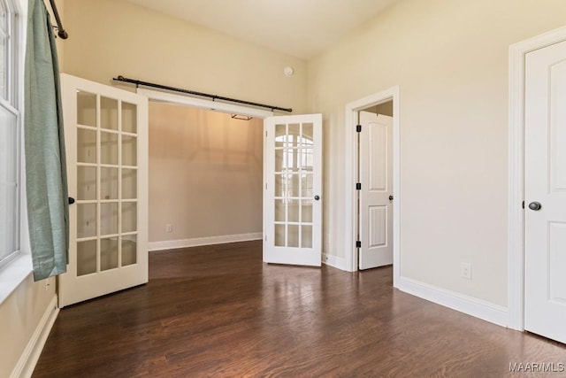 spare room with french doors, baseboards, and wood finished floors