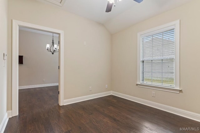 empty room featuring ceiling fan with notable chandelier, dark wood-style floors, and plenty of natural light