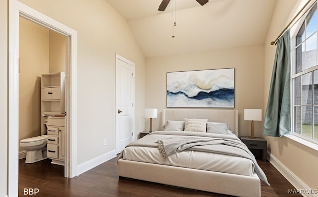 bedroom featuring baseboards, connected bathroom, lofted ceiling, and dark wood-style floors