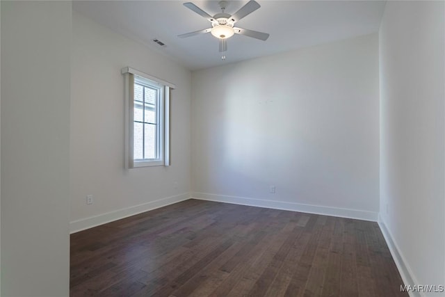 empty room featuring ceiling fan and dark hardwood / wood-style flooring