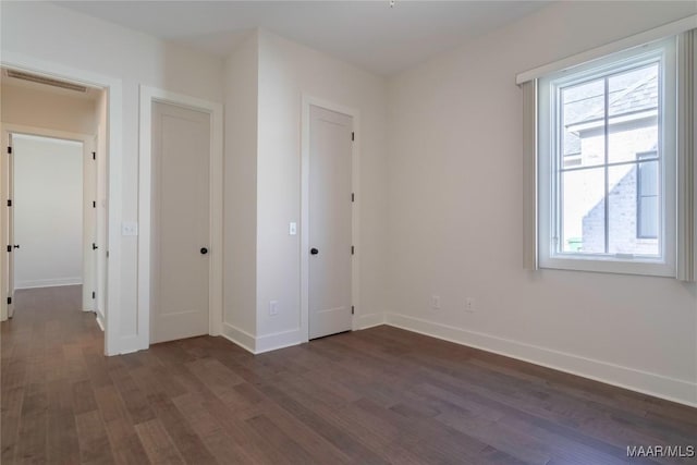 unfurnished bedroom featuring dark wood-type flooring