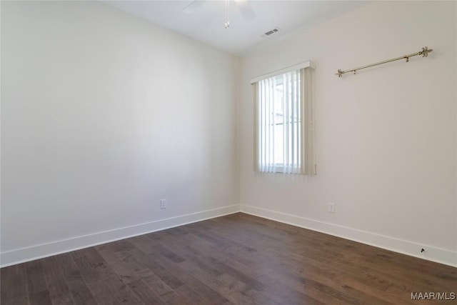 spare room featuring dark hardwood / wood-style floors and ceiling fan