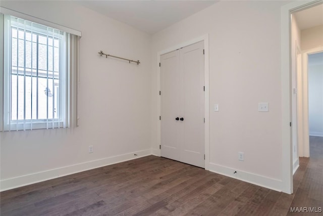 spare room with dark hardwood / wood-style flooring