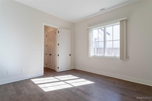 spare room featuring dark hardwood / wood-style floors