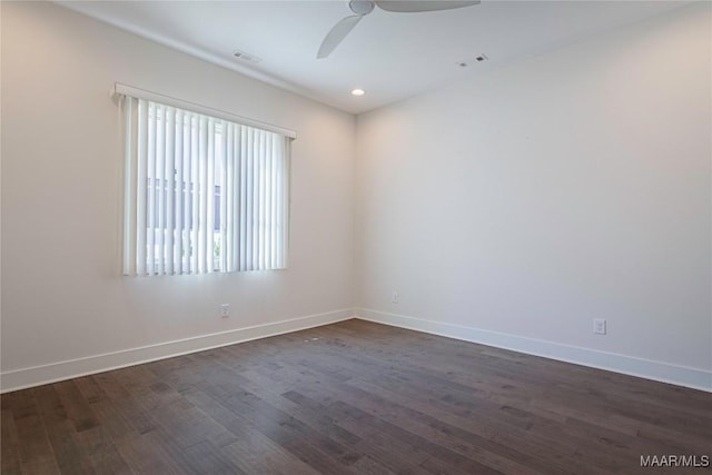 unfurnished room with dark wood-type flooring and ceiling fan