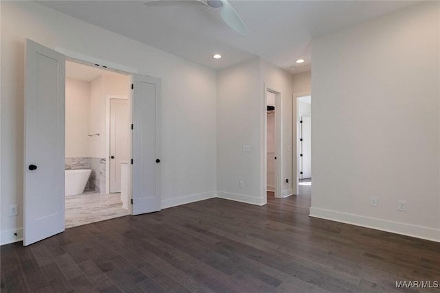 unfurnished bedroom with dark hardwood / wood-style flooring and connected bathroom