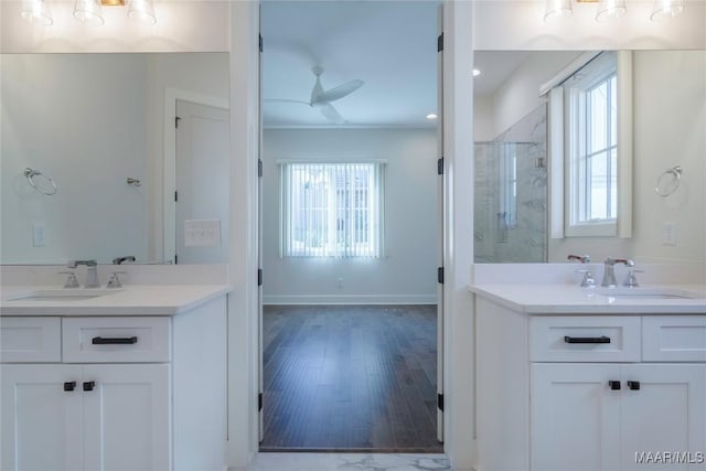 bathroom featuring ceiling fan, vanity, and a wealth of natural light