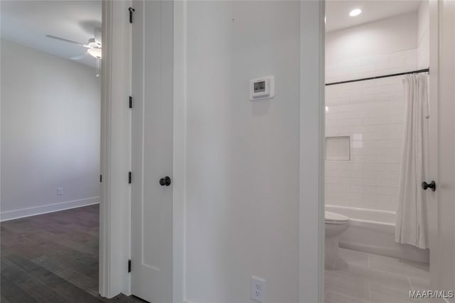 hallway with hardwood / wood-style floors