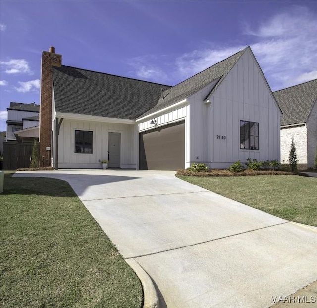 modern farmhouse with a garage and a front lawn