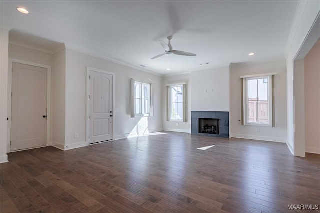 unfurnished living room featuring crown molding, dark wood-type flooring, and a healthy amount of sunlight