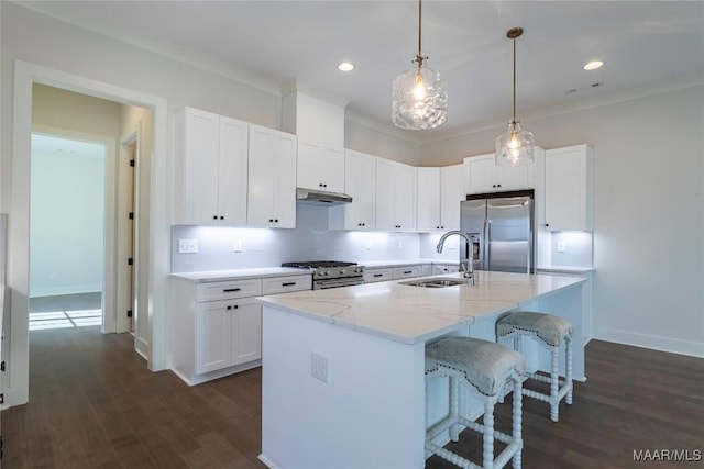 kitchen featuring appliances with stainless steel finishes, sink, and white cabinets