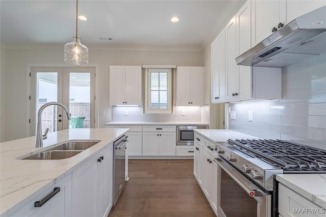 kitchen with sink, stainless steel appliances, white cabinets, and light stone countertops