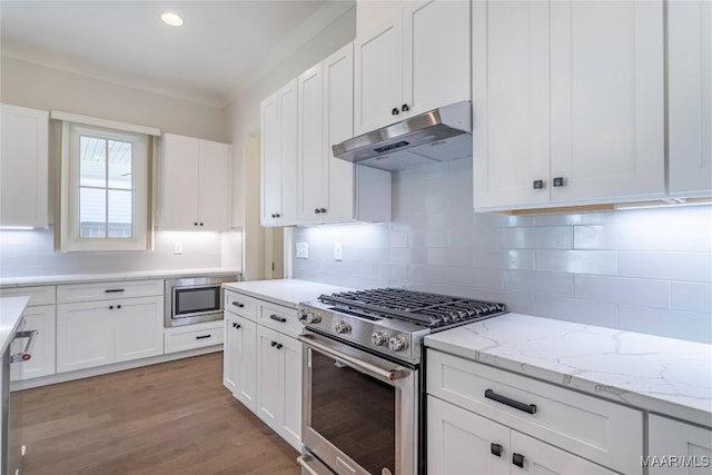 kitchen featuring white cabinetry, appliances with stainless steel finishes, light stone counters, and light hardwood / wood-style flooring