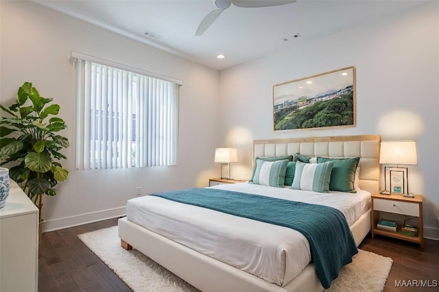 bedroom with dark hardwood / wood-style floors and ceiling fan