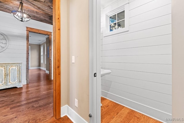 bathroom with crown molding, wood ceiling, hardwood / wood-style flooring, and wood walls