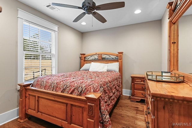 bedroom with dark wood-type flooring and ceiling fan