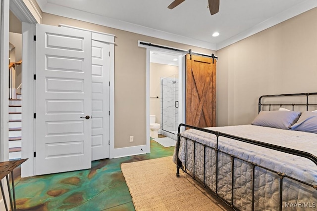 bedroom featuring ornamental molding, a barn door, ceiling fan, and ensuite bathroom