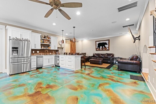 interior space with pendant lighting, white cabinetry, stainless steel fridge, backsplash, and kitchen peninsula