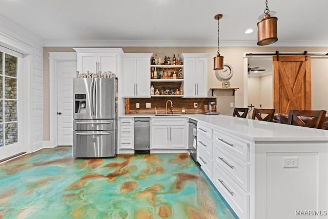 kitchen with sink, decorative light fixtures, stainless steel appliances, and white cabinets