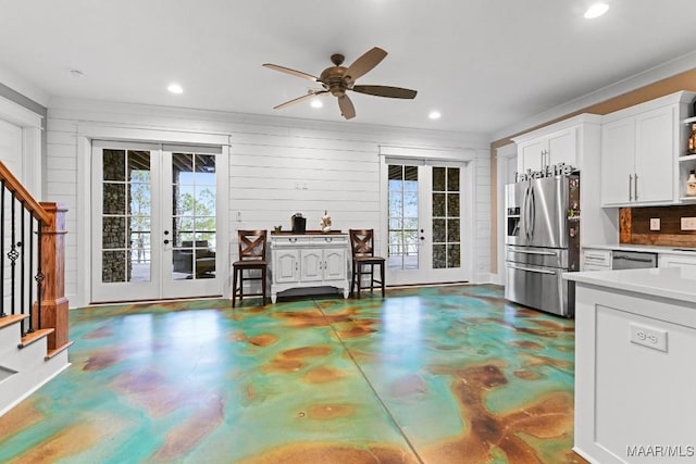 kitchen with white cabinetry, stainless steel appliances, french doors, and a healthy amount of sunlight