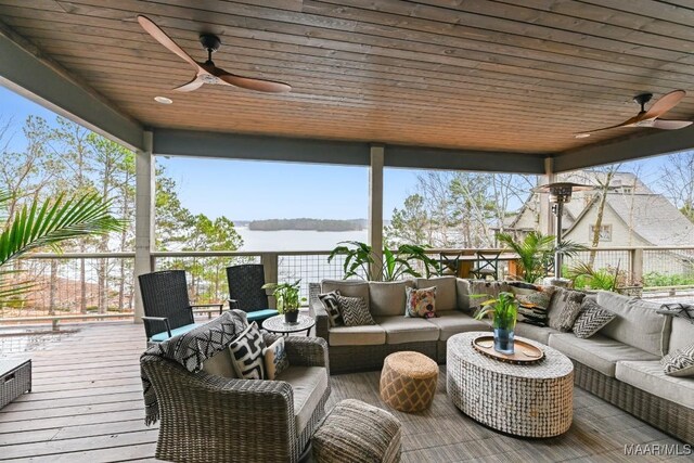 wooden terrace featuring a water view, ceiling fan, and outdoor lounge area