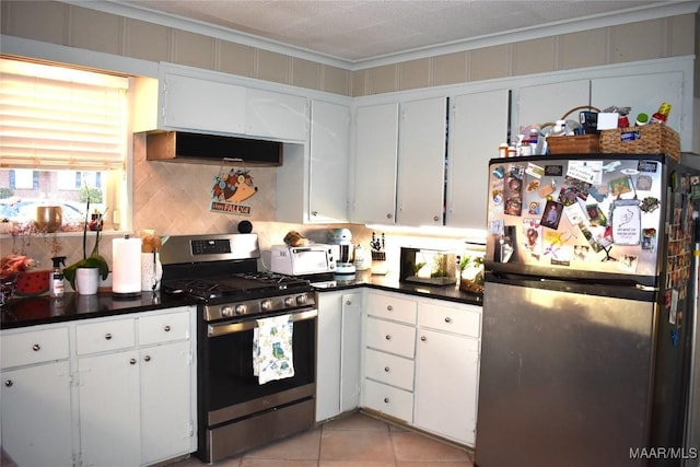 kitchen featuring appliances with stainless steel finishes, tasteful backsplash, white cabinetry, light tile patterned floors, and crown molding