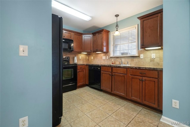 kitchen with sink, dark stone countertops, hanging light fixtures, tasteful backsplash, and black appliances