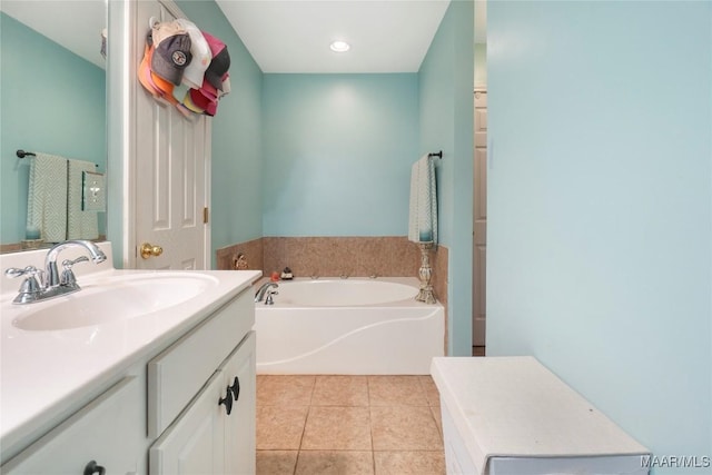 bathroom with tile patterned flooring, vanity, and a bathing tub