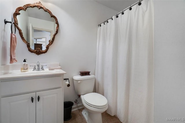 bathroom featuring vanity, toilet, and tile patterned flooring