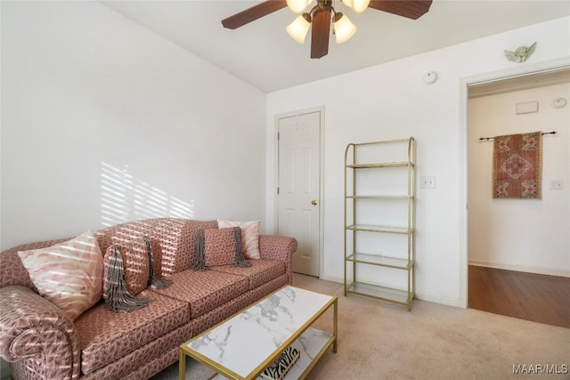 living room with ceiling fan and light colored carpet