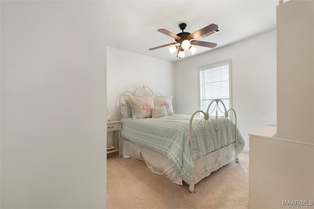 bedroom featuring light colored carpet and ceiling fan