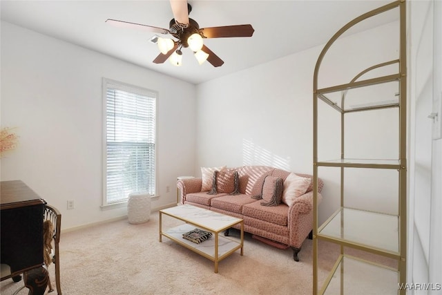 carpeted living room with ceiling fan