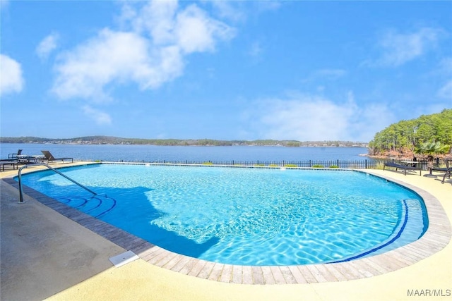 view of swimming pool with a water view