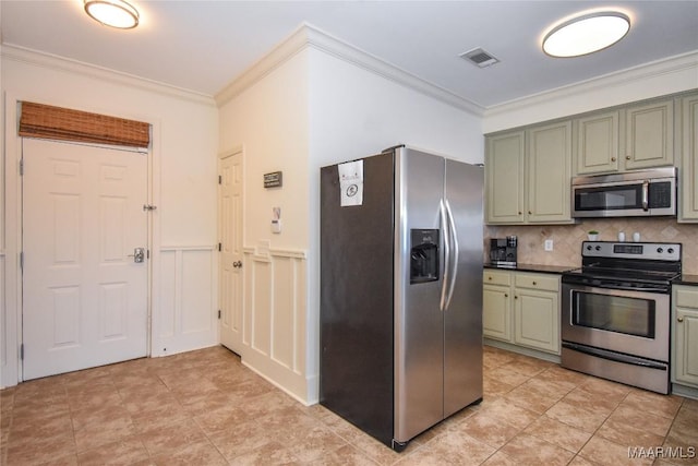 kitchen with crown molding, stainless steel appliances, green cabinets, and backsplash