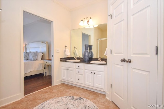 bathroom featuring ornamental molding, an enclosed shower, tile patterned flooring, and vanity