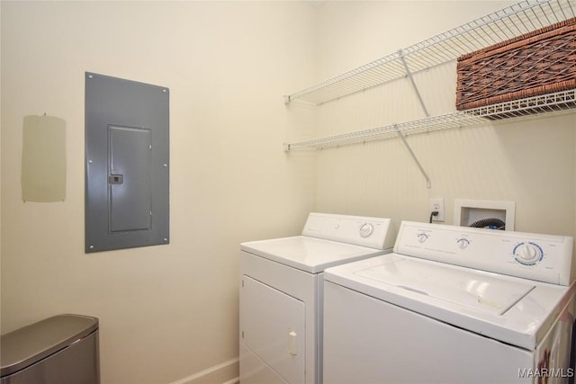 clothes washing area with electric panel and washer and dryer