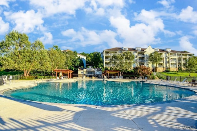 view of swimming pool featuring a pergola and a patio