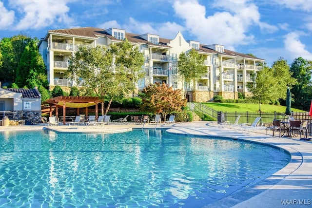 view of swimming pool featuring a pergola and a patio