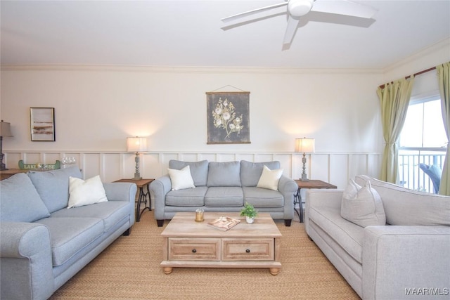 living room featuring ornamental molding and ceiling fan