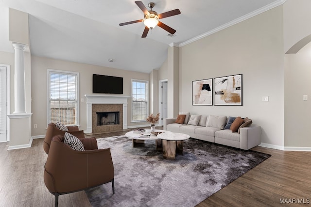 living room with decorative columns, hardwood / wood-style floors, and a wealth of natural light