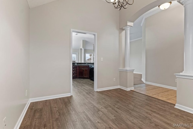 interior space featuring hardwood / wood-style flooring and ornate columns