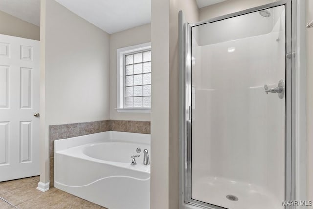 bathroom with separate shower and tub and tile patterned floors