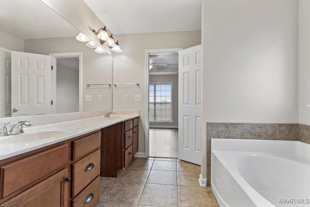 bathroom featuring vanity, a bath, and tile patterned flooring