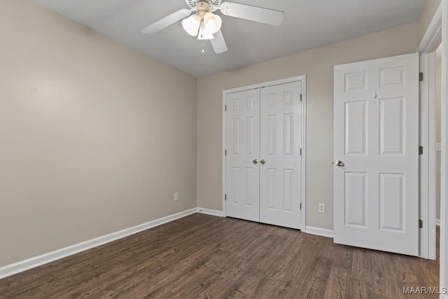 unfurnished bedroom with ceiling fan, dark hardwood / wood-style floors, and a closet