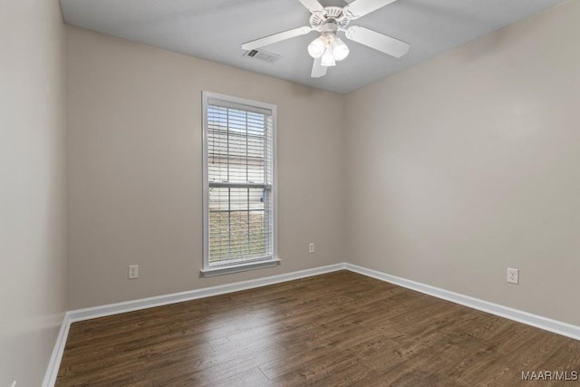 unfurnished room featuring dark wood-type flooring and ceiling fan