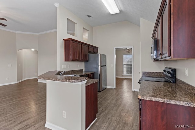 kitchen with sink, appliances with stainless steel finishes, dark hardwood / wood-style floors, ceiling fan, and dark stone counters