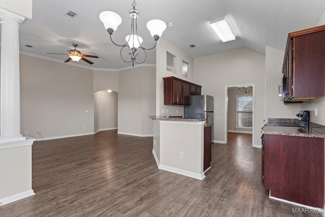 kitchen with decorative columns, pendant lighting, ceiling fan with notable chandelier, and stainless steel refrigerator