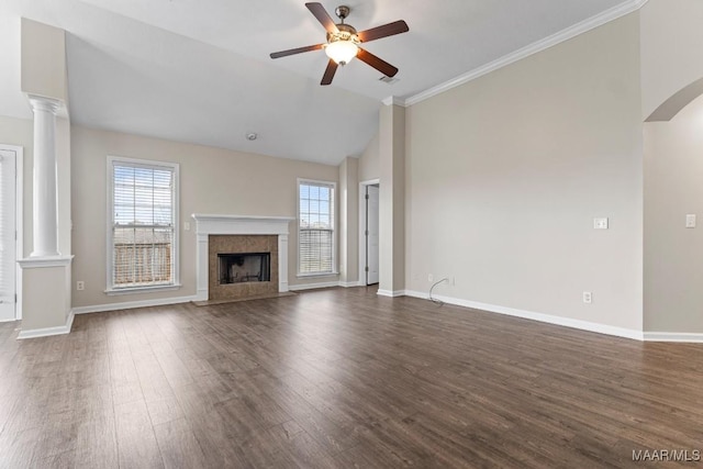 unfurnished living room featuring decorative columns, a premium fireplace, dark wood-type flooring, and ceiling fan