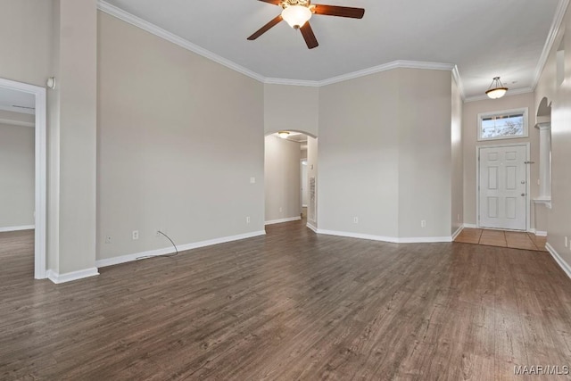 unfurnished living room featuring crown molding, ceiling fan, and dark hardwood / wood-style floors